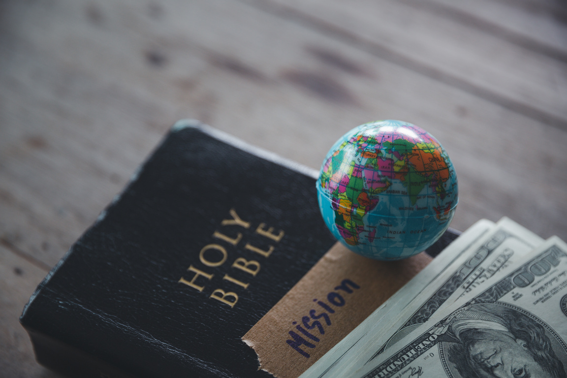 Globe with Holy Bible for mission, Mission christian idea. bible and book on wooden table, Christian background for great commission